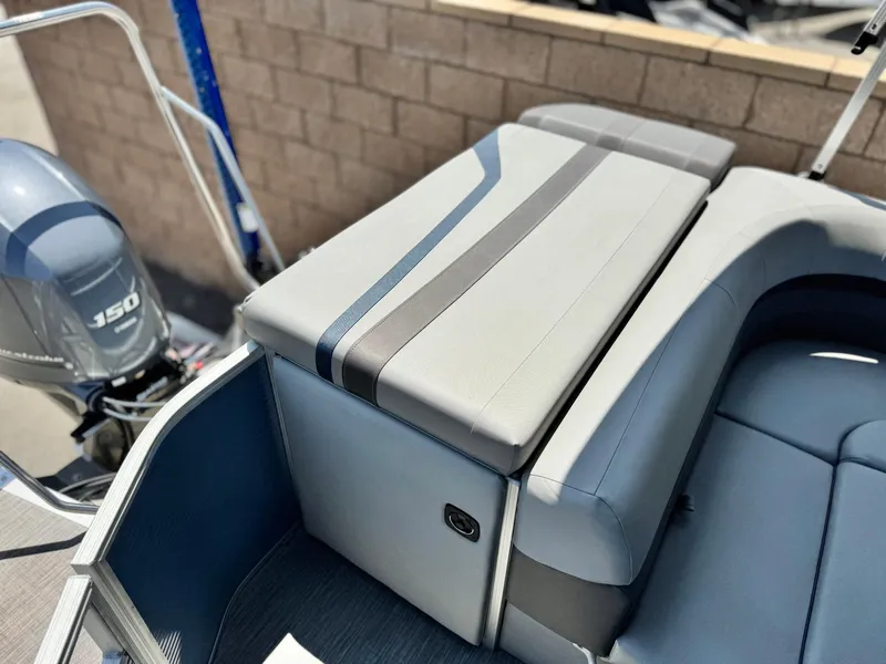 Slide: The Image of 2023 Bennington SX 21 boat interior with cushioned seating and outboard motor. - 16