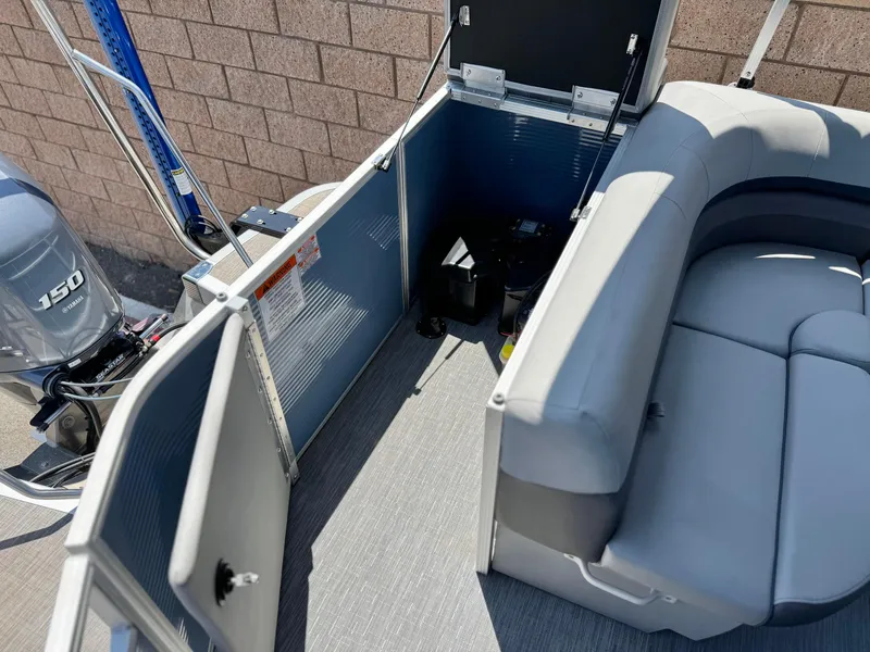 Slide: The Image of 2023 Bennington SX 21 pontoon boat interior with seating and outboard motor. - 17