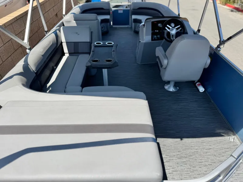 Slide: The Image of 2023 Bennington SX 21 pontoon boat interior with gray seating and steering console. - 20