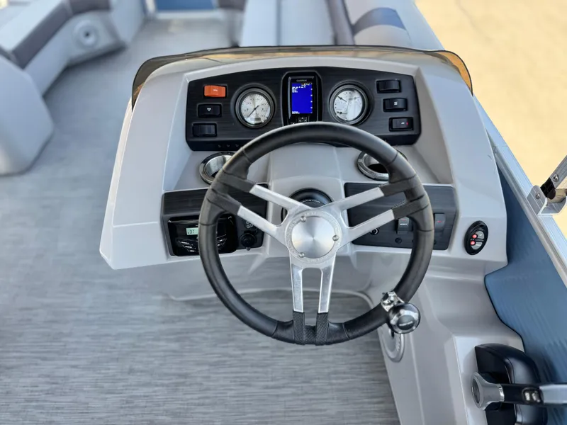 Slide: The Image of 2023 Bennington SX 21 boat dashboard with steering wheel and instrument panel. - 22