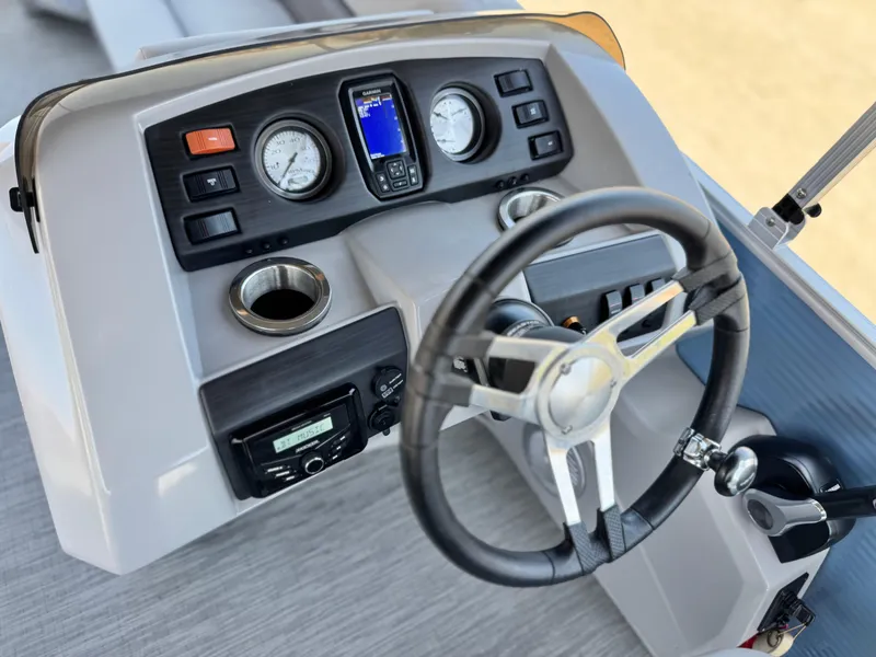 Slide: The Image of 2023 Bennington SX 21 boat dashboard with steering wheel, gauges, and controls. - 23
