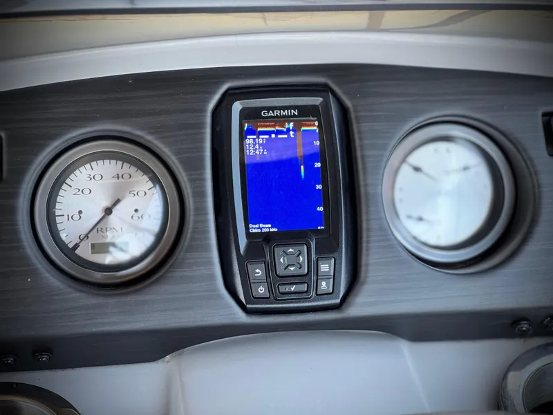 Slide: The Image of Dashboard of 2023 Bennington SX 21 with Garmin display and gauges. - 25