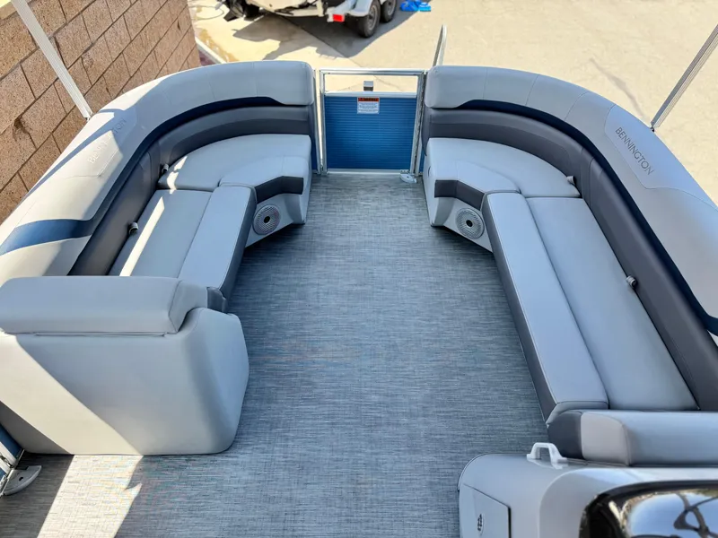 Slide: The Image of 2023 Bennington SX 21 pontoon boat interior with gray seating and carpeted floor. - 9