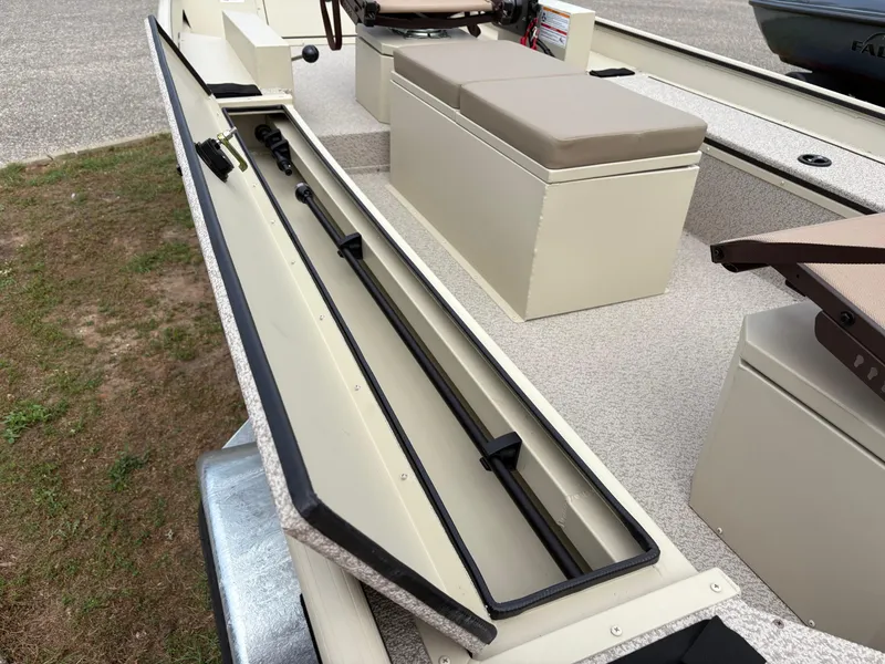 Slide: The Image of 2025 SeaArk 1652 Crappie boat interior with rod storage compartment open. - 10