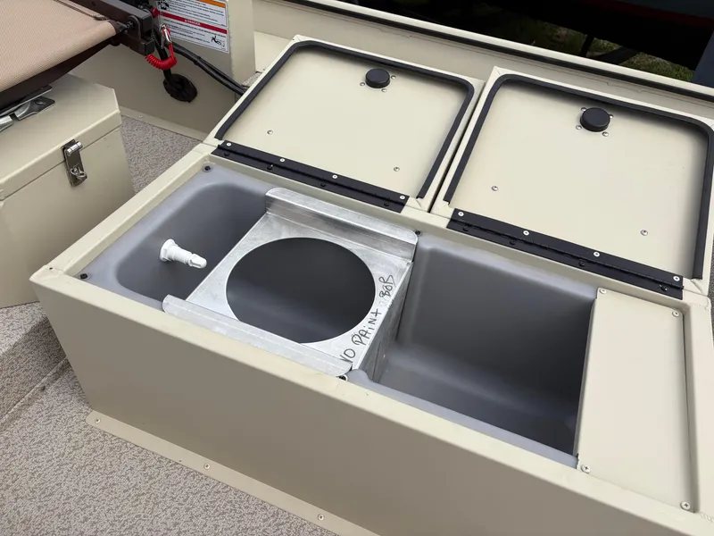 Slide: The Image of 2025 SeaArk 1652 Crappie boat storage compartments with open lids. - 11