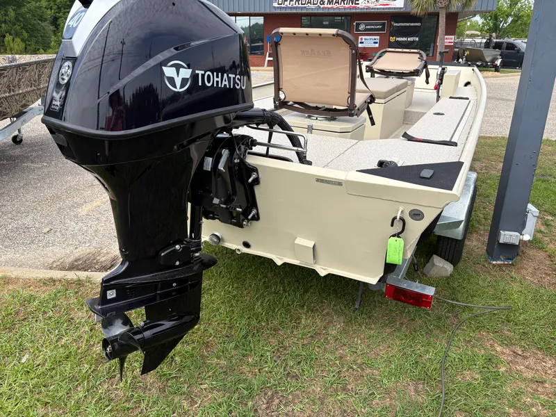Slide: The Image of 2025 SeaArk 1652 Crappie boat with Tohatsu outboard motor, parked on grass. - 12
