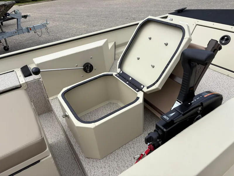 Slide: The Image of 2025 SeaArk 1652 Crappie boat interior with storage compartment and control handle. - 6