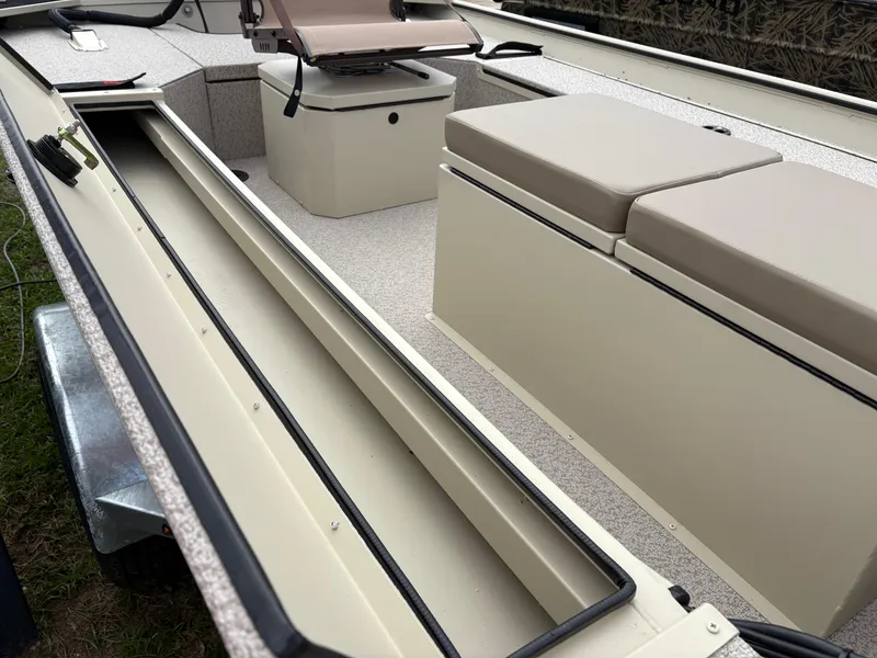 Slide: The Image of 2025 SeaArk 1652 Crappie boat interior with seating and storage compartments. - 7