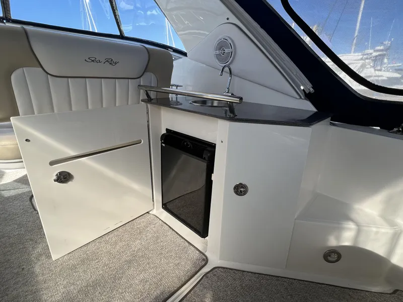 Slide: The Image of Interior of 2012 Sea Ray 310 Sundancer yacht with seating and kitchenette area. - 10