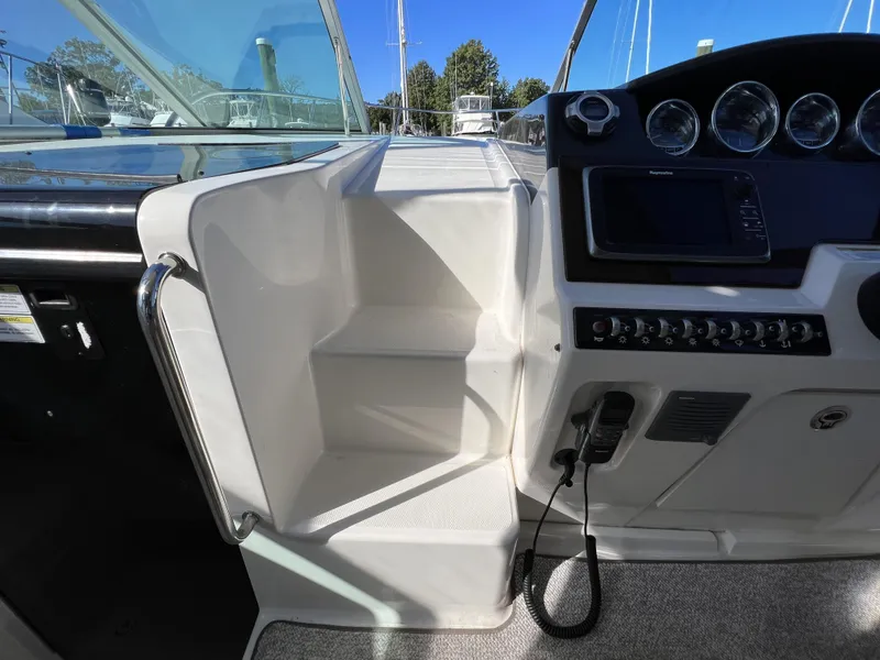 Slide: The Image of Helm of 2012 Sea Ray 310 Sundancer with gauges, steering wheel, and controls. - 15