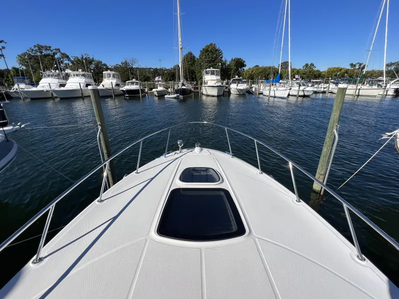Slide: The Image of 2012 Sea Ray 310 Sundancer helm with control panel and steps. - 16