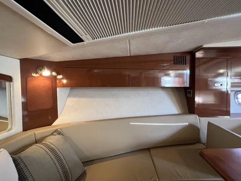 Slide: The Image of Luxurious interior of 2012 Sea Ray 310 Sundancer yacht with wood finishes and seating area. - 21