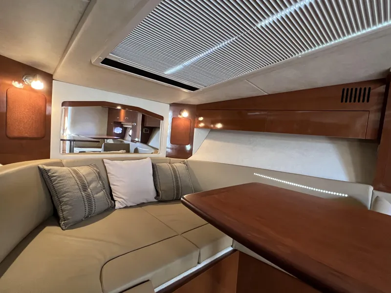 Slide: The Image of Interior cabin of 2012 Sea Ray 310 Sundancer, featuring cozy sleeping area and storage. - 24
