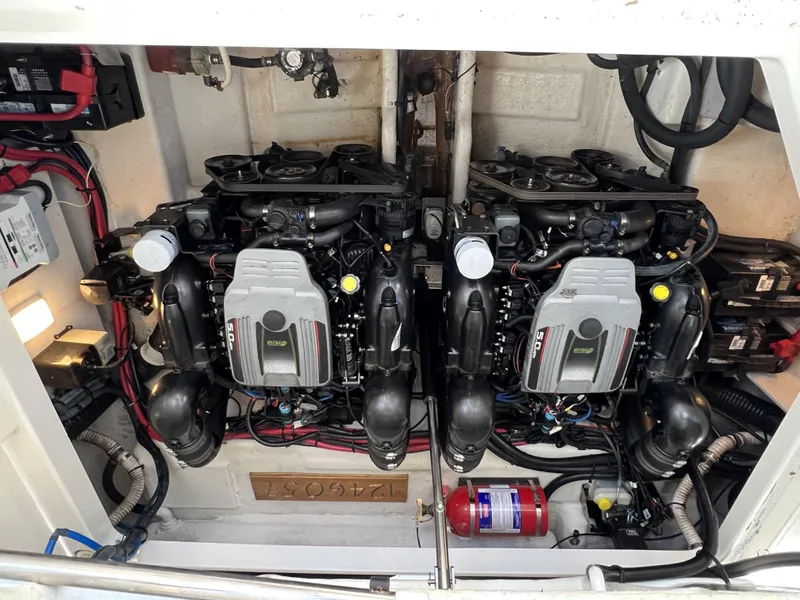 Slide: The Image of Engine compartment of a 2012 Sea Ray 310 Sundancer with dual engines and wiring. - 26