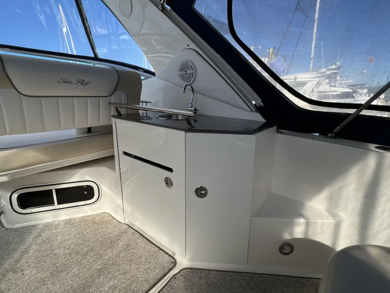 Slide: The Image of Interior of 2012 Sea Ray 310 Sundancer boat with plush seating and panoramic windows. - 9