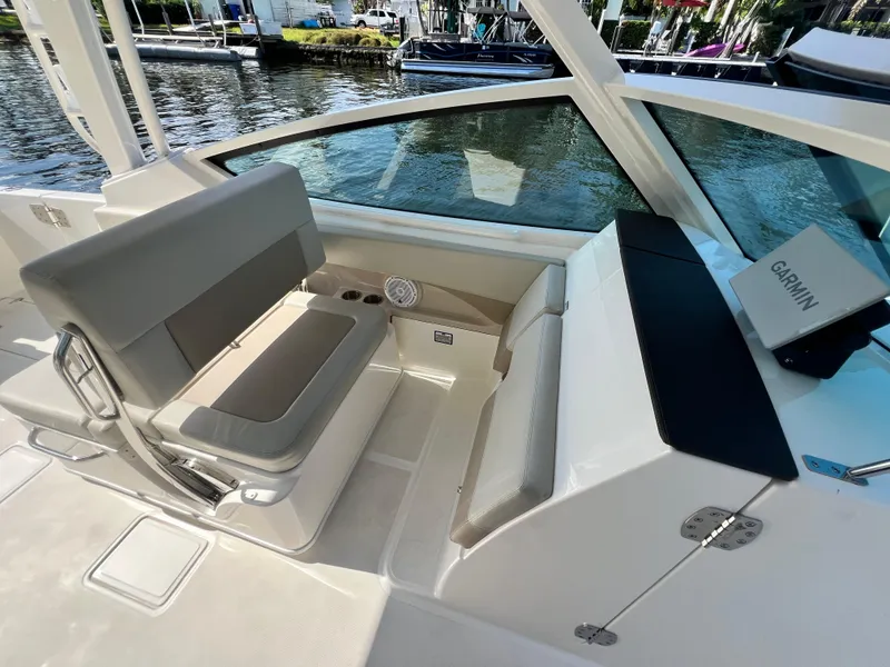Slide: The Image of 2023 Boston Whaler 280 Vantage boat interior with seating and Garmin navigation system. - 14