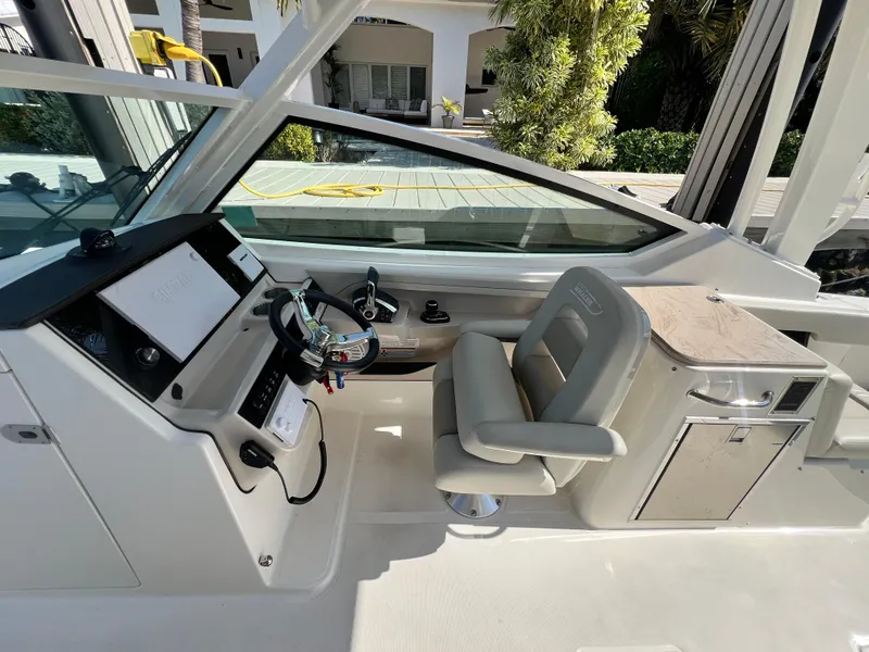 Slide: The Image of 2023 Boston Whaler 280 Vantage cockpit with helm, seating, and control panel. - 17