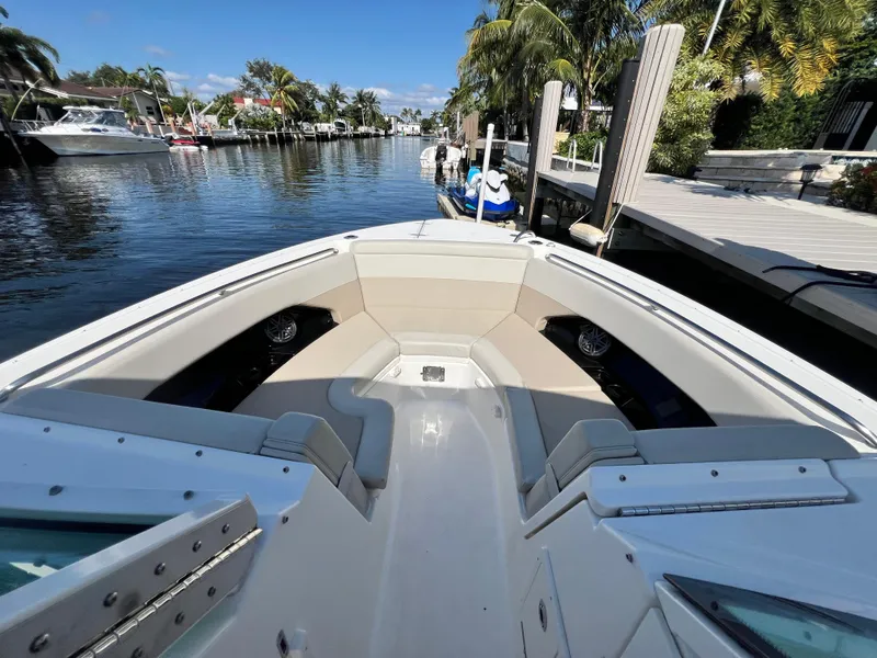 Slide: The Image of 2023 Boston Whaler 280 Vantage boat docked in a scenic canal setting. - 20