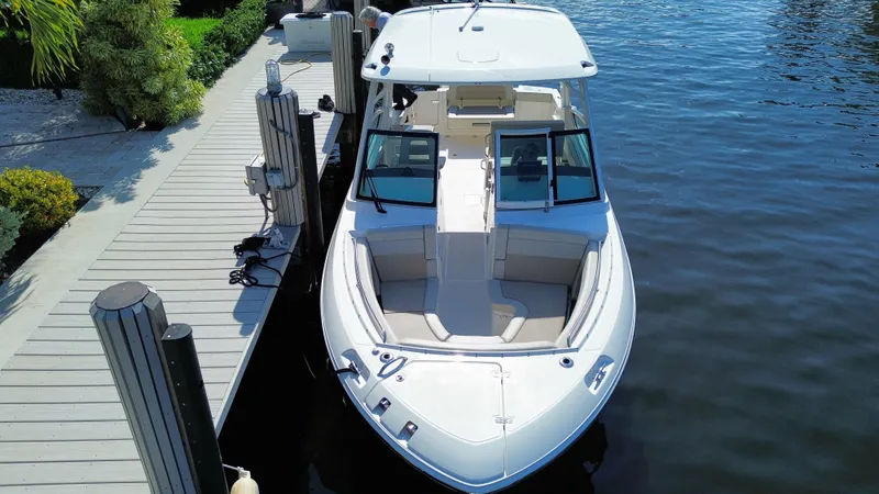 Slide: The Image of 2023 Boston Whaler 280 Vantage docked on calm water, showcasing sleek design. - 5