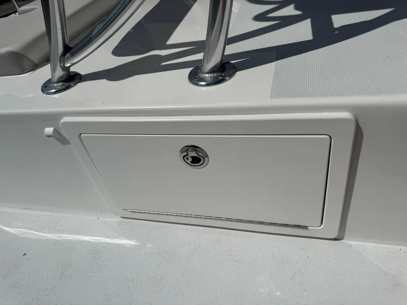 Slide: The Image of 2019 Shallow Sport 21 Sport boat storage compartment with stainless steel railing. - 12