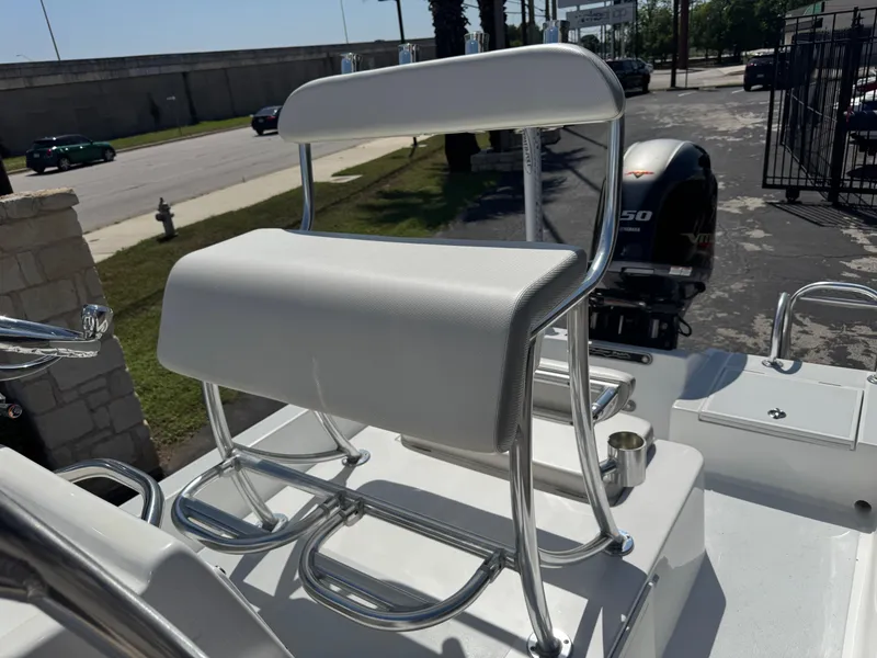 Slide: The Image of 2019 Shallow Sport 21 Sport boat with white seating and a 150 HP outboard motor. - 15