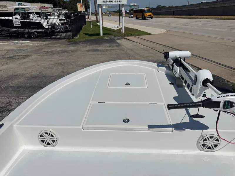 Slide: The Image of 2019 Shallow Sport 21 Sport boat with trolling motor on a paved lot. - 22