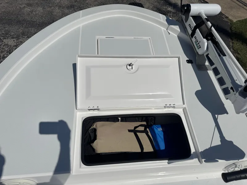 Slide: The Image of 2019 Shallow Sport 21 Sport boat deck with open storage compartment. - 24