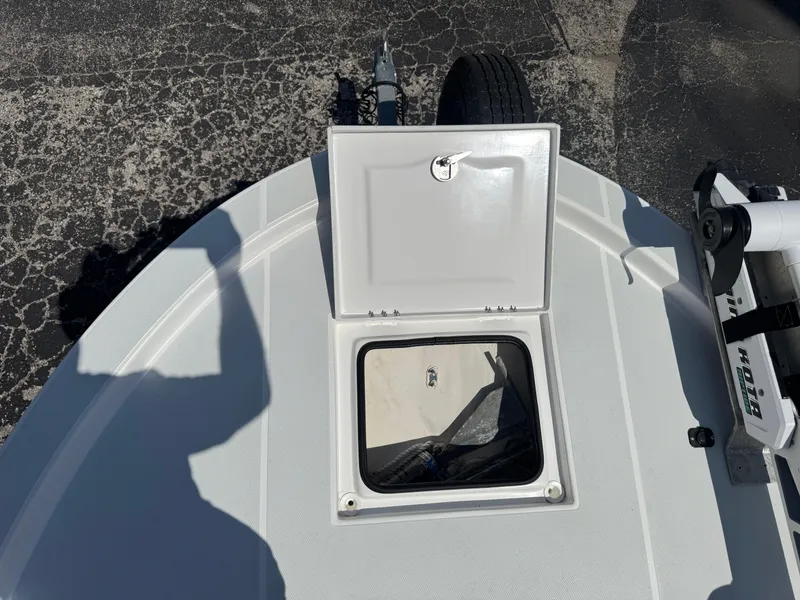 Slide: The Image of 2019 Shallow Sport 21 Sport boat deck with open storage hatch. - 25