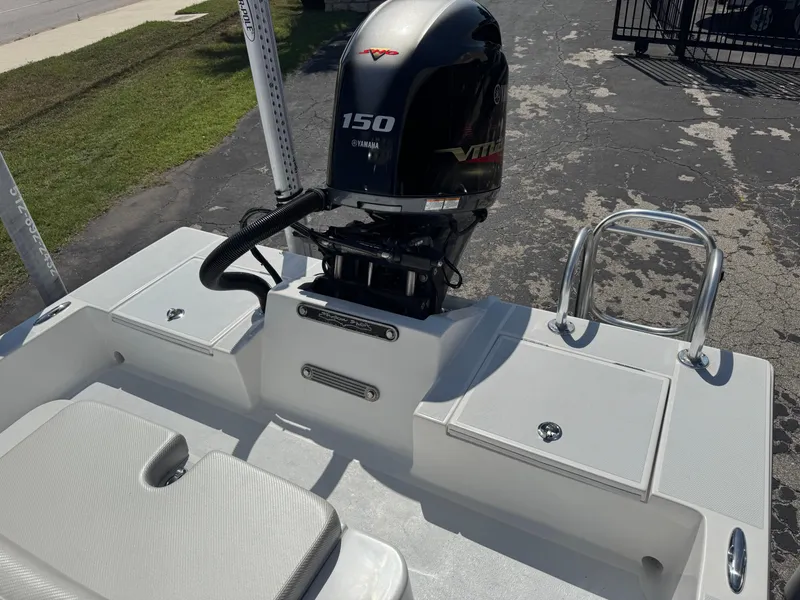 Slide: The Image of 2019 Shallow Sport 21 Sport boat with Yamaha 150 engine, parked on pavement. - 26
