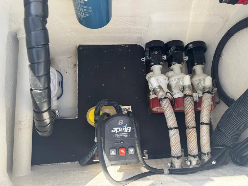 Slide: The Image of 2019 Shallow Sport 21 Sport boat bilge area with pumps and wiring. - 29