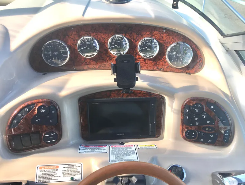 Slide: The Image of Dashboard of a 2004 Sea Ray 340 Sundancer boat with gauges and controls. - 11
