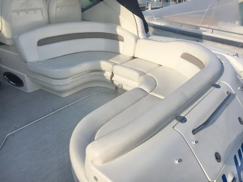 Slide: The Image of 2004 Sea Ray 340 Sundancer boat with white leather seating in the cockpit area. - 14