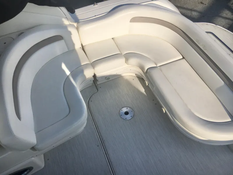 Slide: The Image of 2004 Sea Ray 340 Sundancer boat interior with curved white seating. - 15