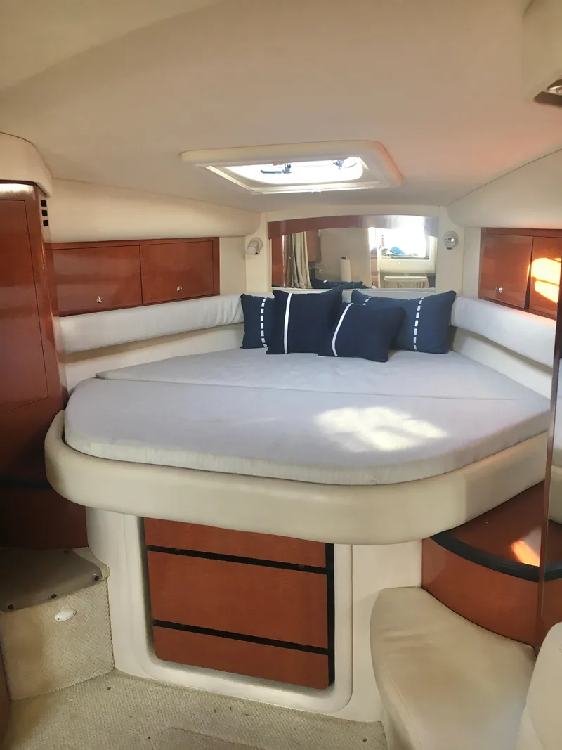 Slide: The Image of Interior of 2004 Sea Ray 340 Sundancer with cozy bed and elegant wood finish. - 17