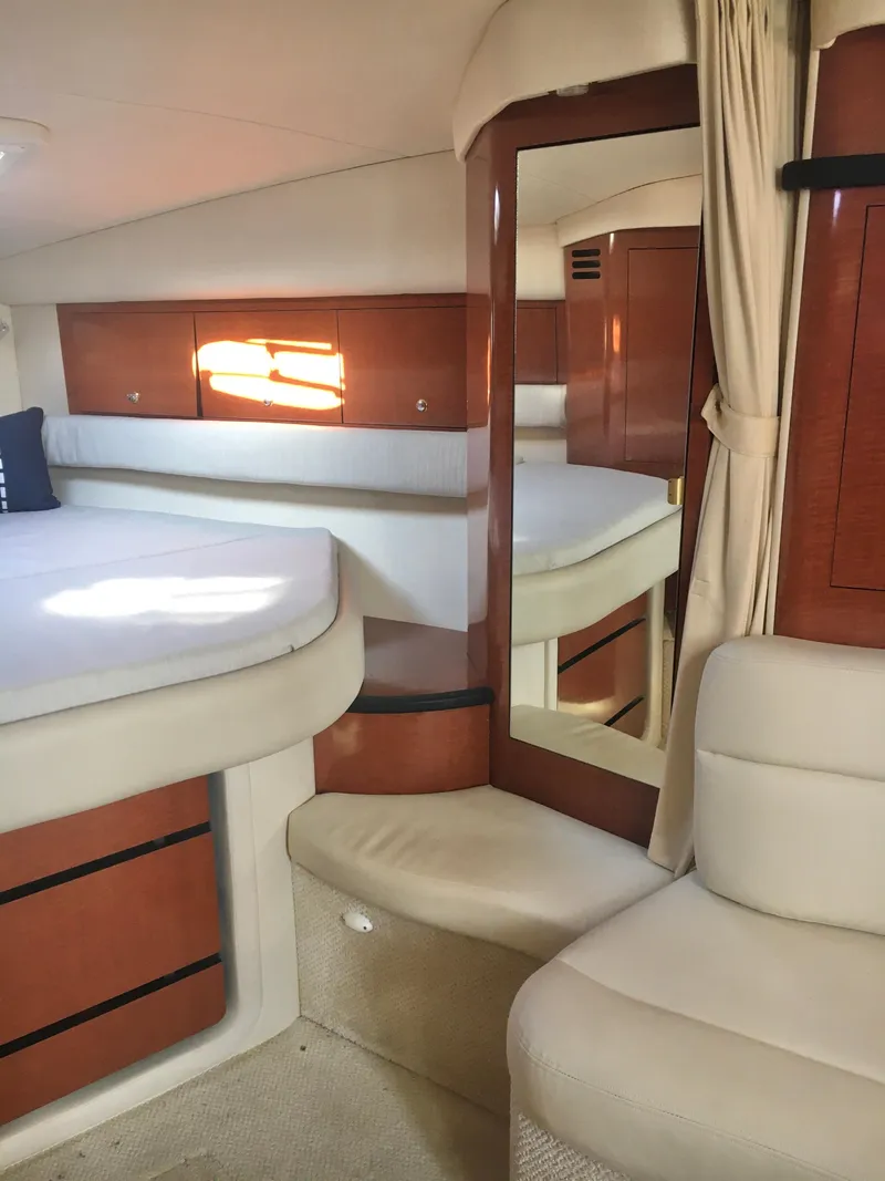 Slide: The Image of Interior of 2004 Sea Ray 340 Sundancer yacht with bed, mirror, and seating area. - 19