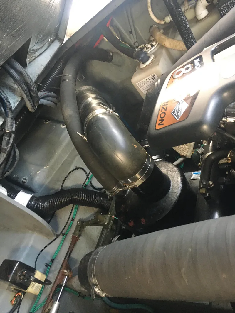 Slide: The Image of Engine compartment of a 2004 Sea Ray 340 Sundancer boat, showing hoses and components. - 27