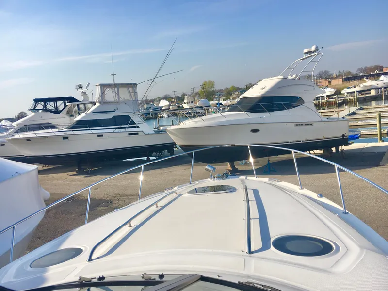 Slide: The Image of 2004 Sea Ray 340 Sundancer docked among other boats at a marina. - 4