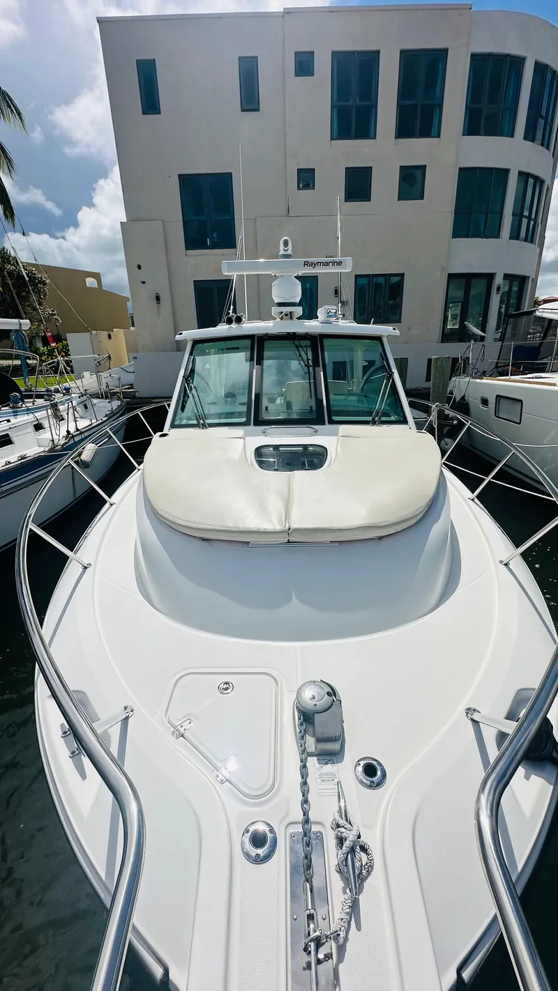 Slide: The Image of 2018 Boston Whaler 345 Conquest docked near modern building. - 14