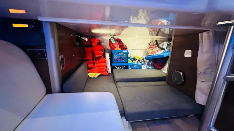 Slide: The Image of Interior cabin of 2018 Boston Whaler 345 Conquest with storage and life jackets. - 17