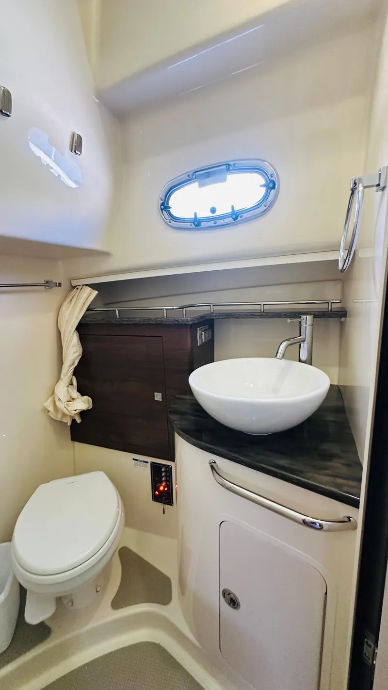 Slide: The Image of 2018 Boston Whaler 345 Conquest bathroom with modern sink, toilet, and porthole window. - 22