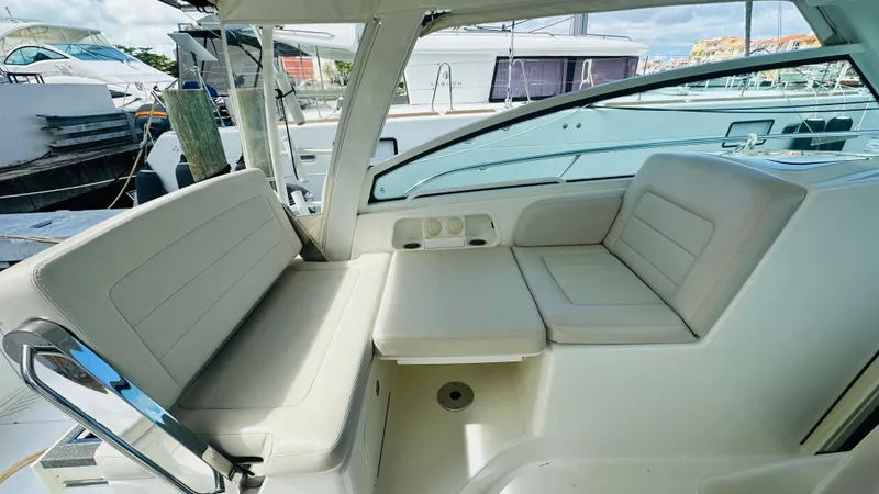 Slide: The Image of 2018 Boston Whaler 345 Conquest interior seating area with cushioned benches and sleek design. - 9