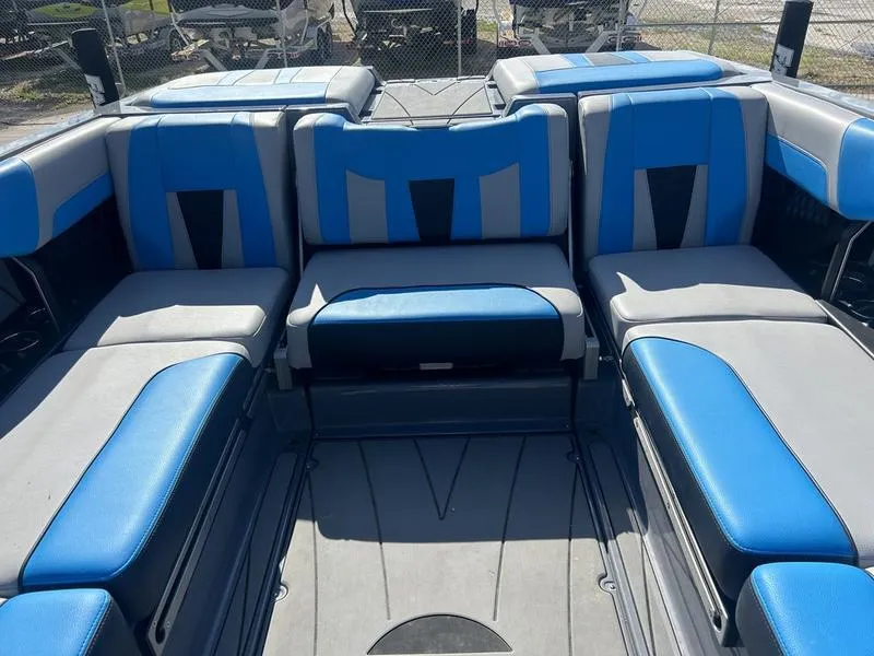 Slide: The Image of 2022 Malibu Wakesetter 23 LSV boat interior with blue and gray seating. - 2