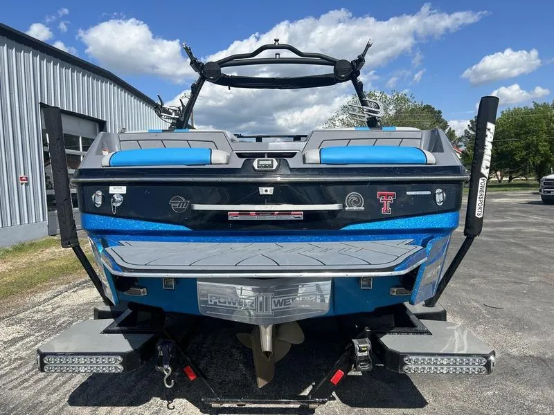 Slide: The Image of 2022 Malibu Wakesetter 23 LSV boat, blue, parked outdoors under a clear sky. - 4