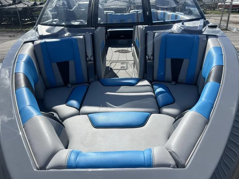Slide: The Image of 2022 Malibu Wakesetter 23 LSV boat interior with blue and gray seating. - 6