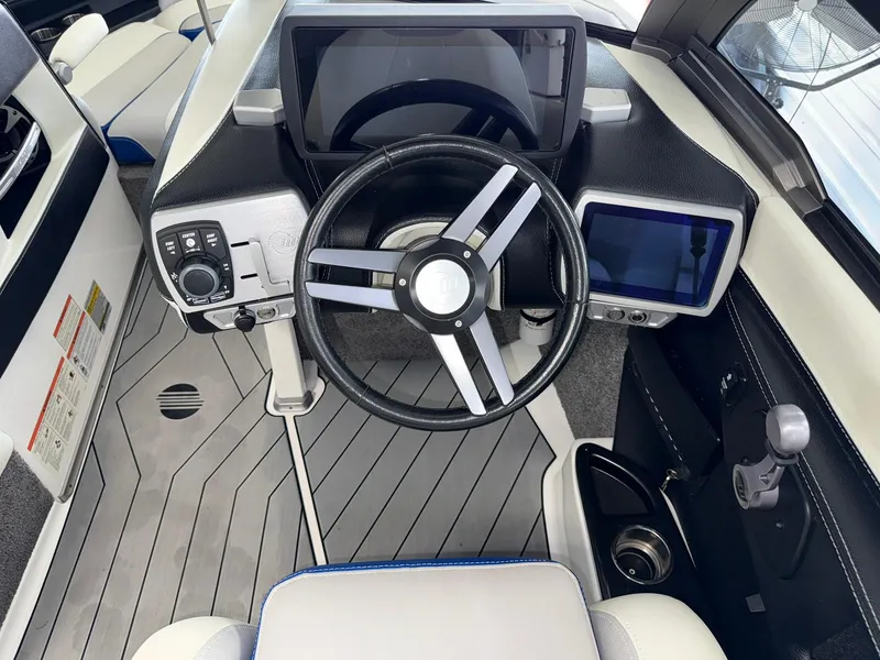 Slide: The Image of 2017 Malibu Wakesetter 23 LSV dashboard with steering wheel and digital displays. - 10