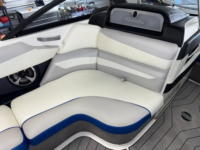 Slide: The Image of 2017 Malibu Wakesetter 23 LSV interior with white and gray seating, blue accents. - 12