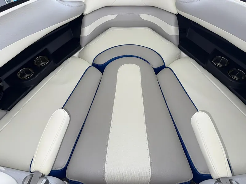 Slide: The Image of 2017 Malibu Wakesetter 23 LSV interior seating with cup holders, white and gray upholstery. - 14