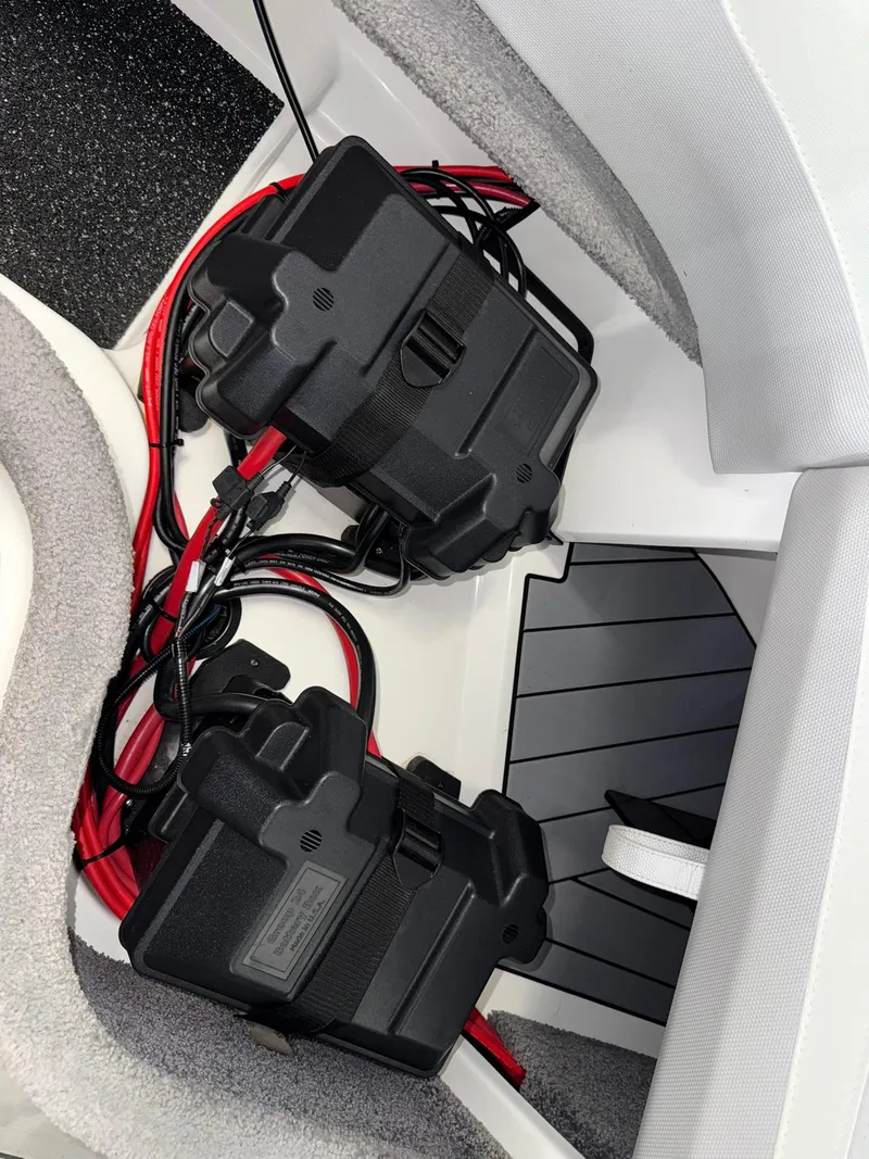 Slide: The Image of 2017 Malibu Wakesetter 23 LSV battery compartment with wiring and protective casings. - 25