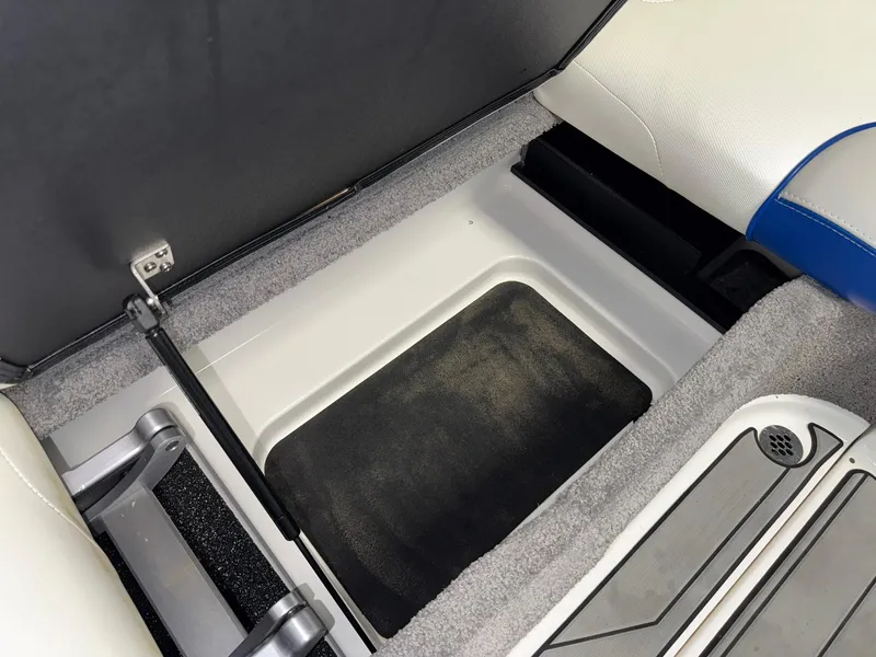Slide: The Image of 2017 Malibu Wakesetter 23 LSV interior storage compartment with cushioned seating. - 26