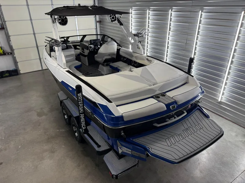 Slide: The Image of 2017 Malibu Wakesetter 23 LSV boat in a garage, featuring sleek design and modern amenities. - 5